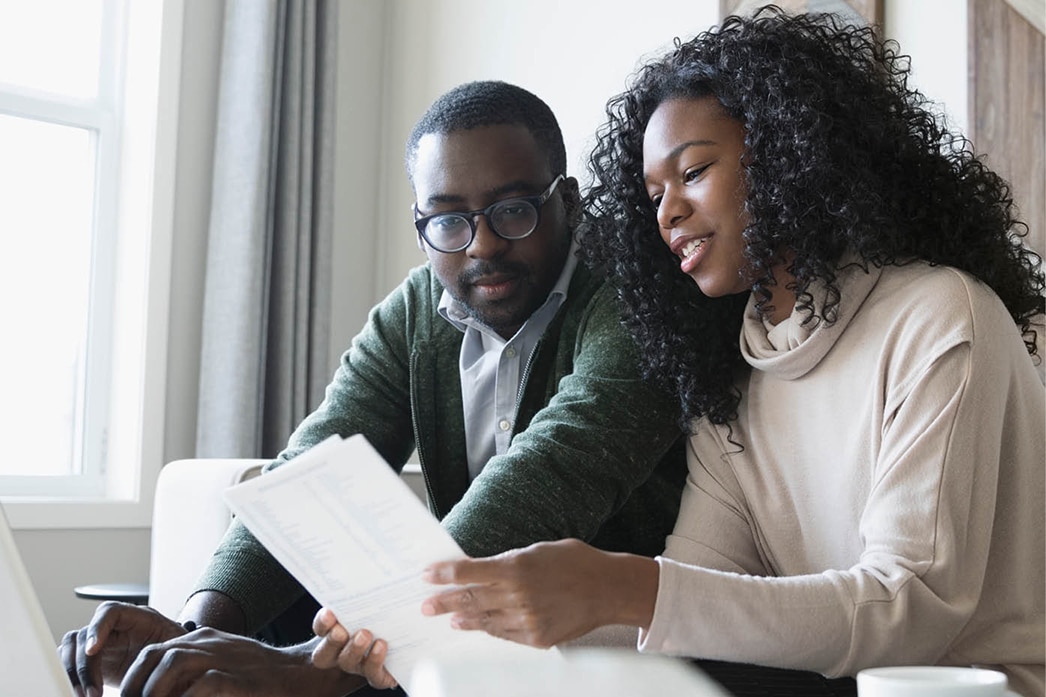 A couple reviewing information together at home