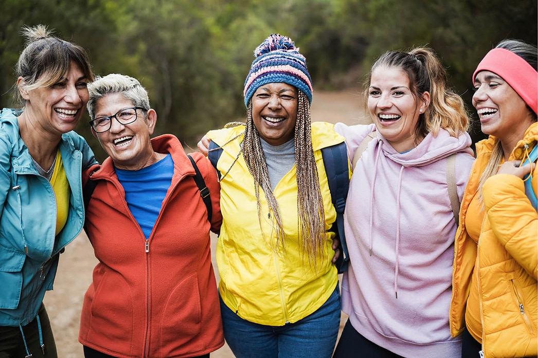 A group of friends laughing together on a hike
