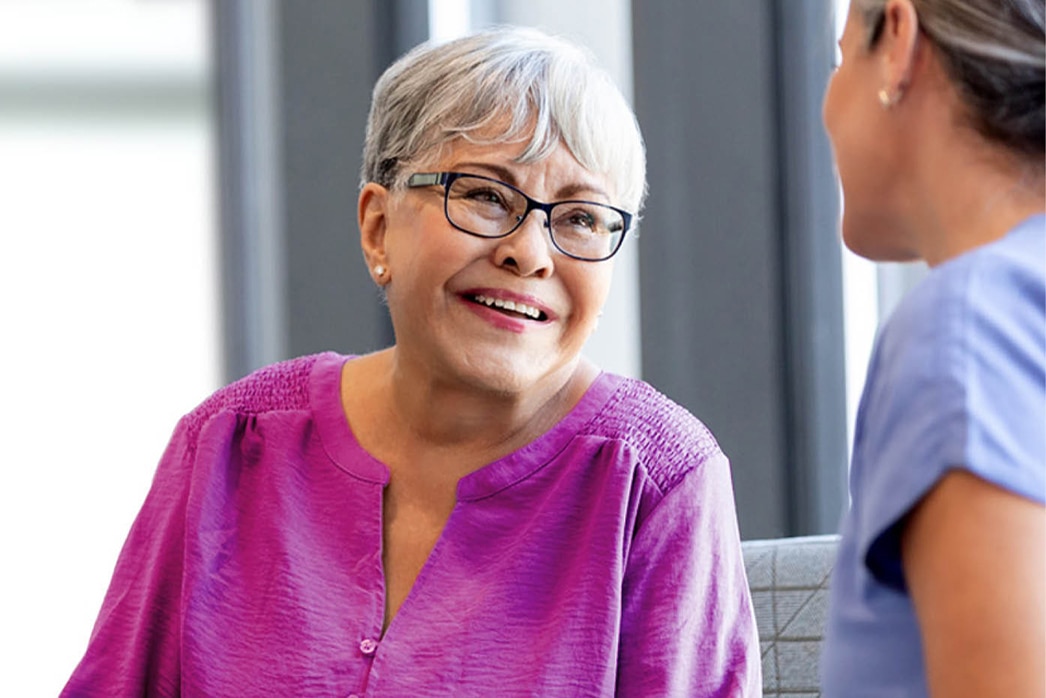 A person smiling during a conversation with a doctor